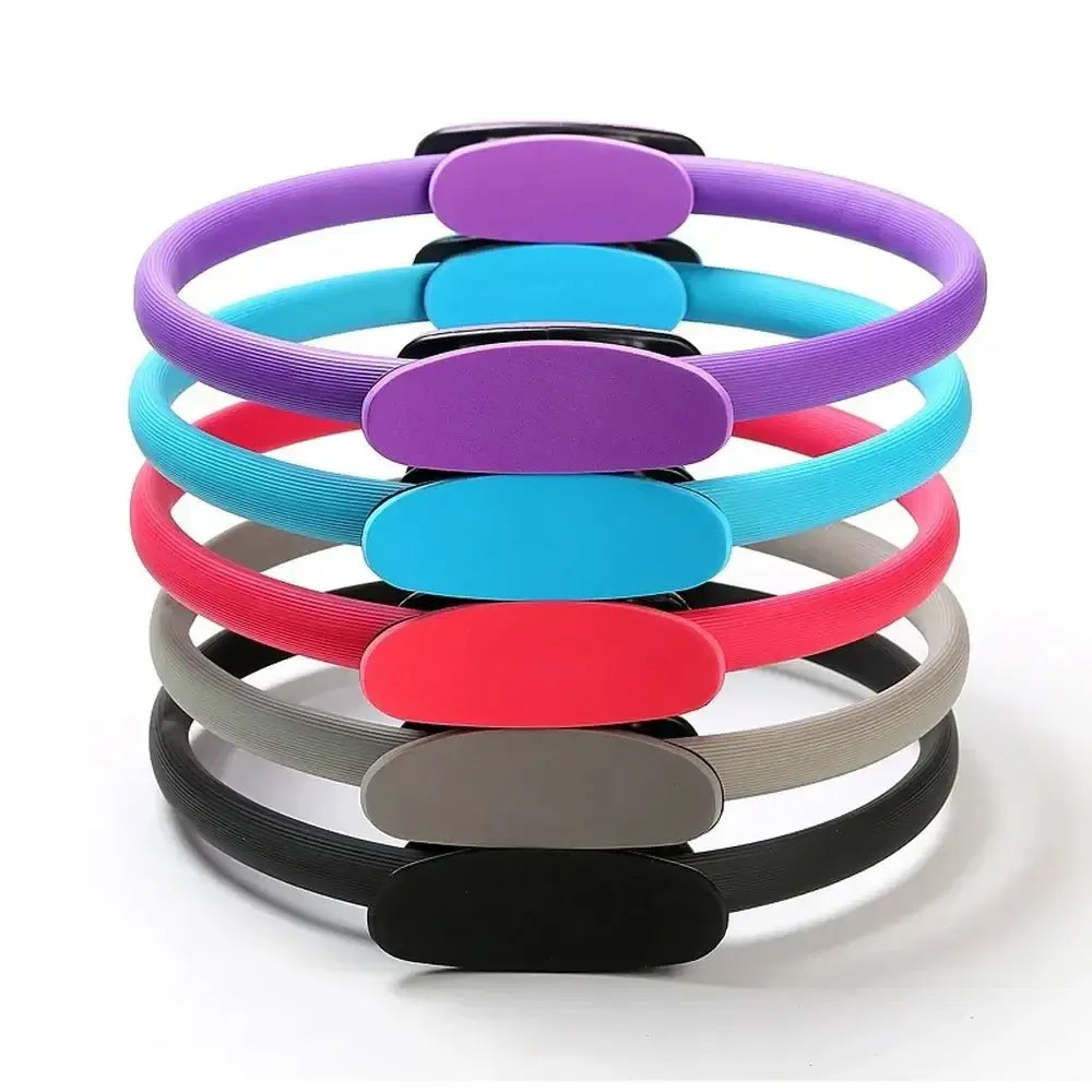 Set of colorful Pilates rings in pink, purple, blue, gray, and black for fitness and body shaping exercises.