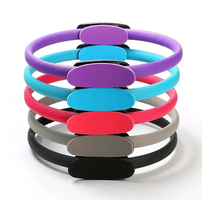 Set of colorful Pilates rings in pink, purple, blue, gray, and black for fitness and body shaping exercises.