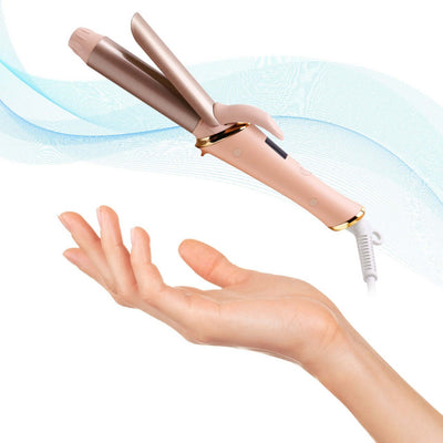 Portable Automatic Hair Curler in a hand, featuring a sleek pink design and easy-to-use features.