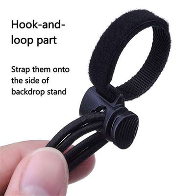 Close-up of hook-and-loop strap designed to secure photography backdrops onto stands with adjustment cord.