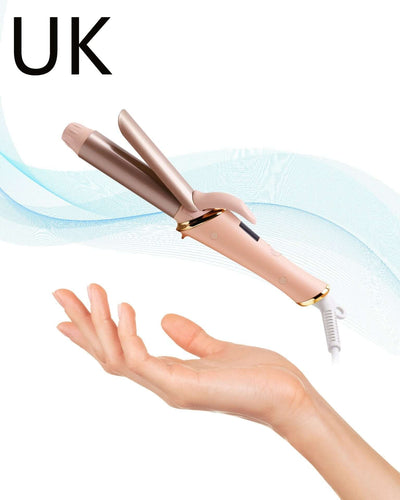 Portable automatic hair curler in pink, designed for UK voltage standards, showcased in a hand against a soft background.