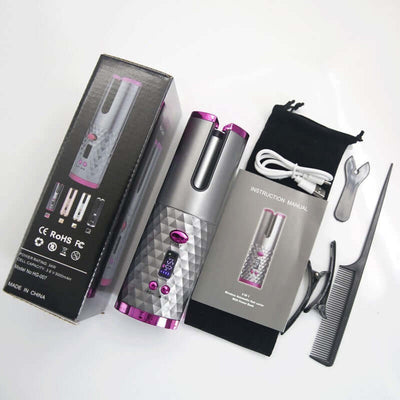 Wireless hair curler in pink and gray with accessories including manual, comb, and charging cable.