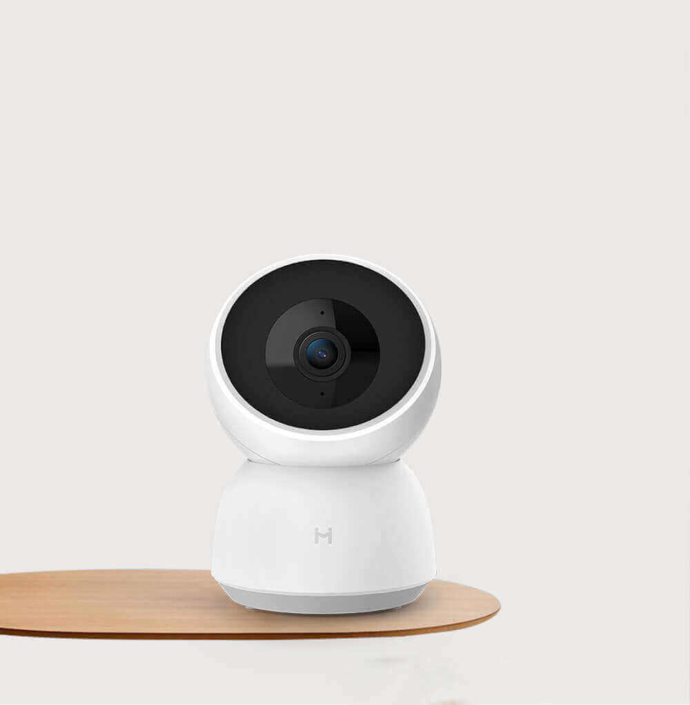 Smart Camera Indoor Baby Monitor with HD 1080P resolution on a wooden surface, designed for secure baby monitoring.