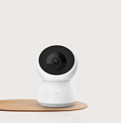 Smart Camera Indoor Baby Monitor with HD 1080P resolution on a wooden surface, designed for secure baby monitoring.