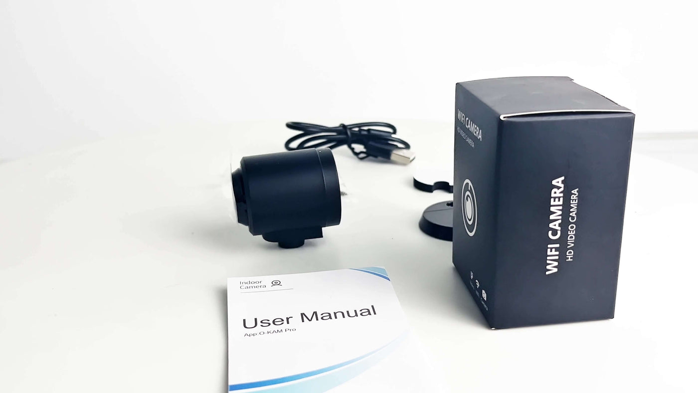 Smart wireless WiFi home security surveillance camera with user manual and packaging on a white background.