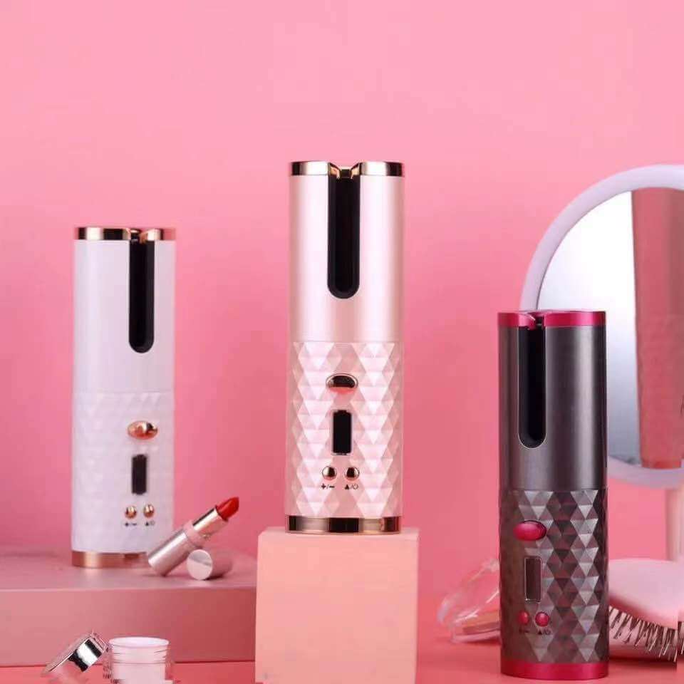 Wireless hair curlers in white, pink, and gray on a pink background, showcasing automatic and portable features.